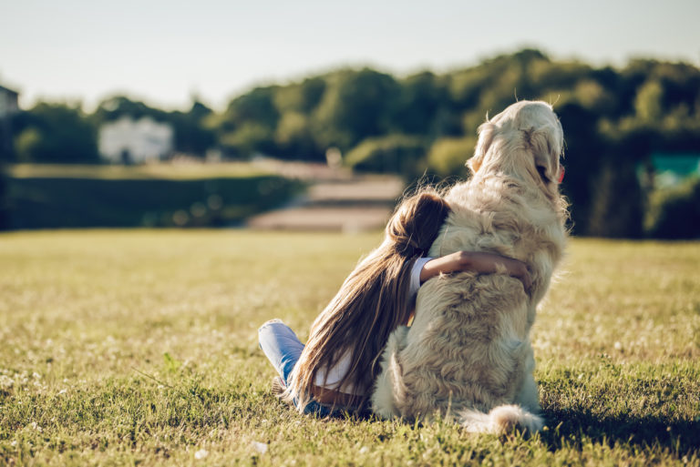 petite fille qui fait un câlin à son chien